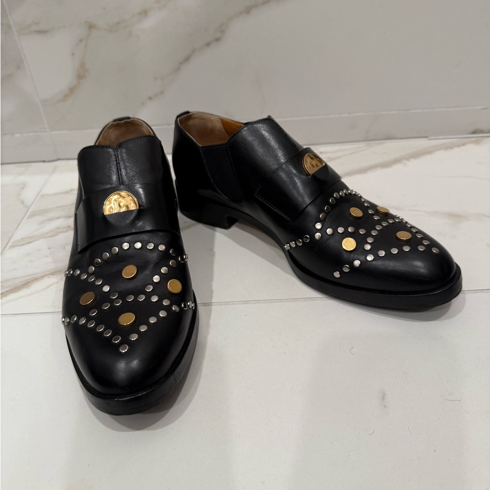 Chloe Glory Black Loafers with Gold and Silver studs.